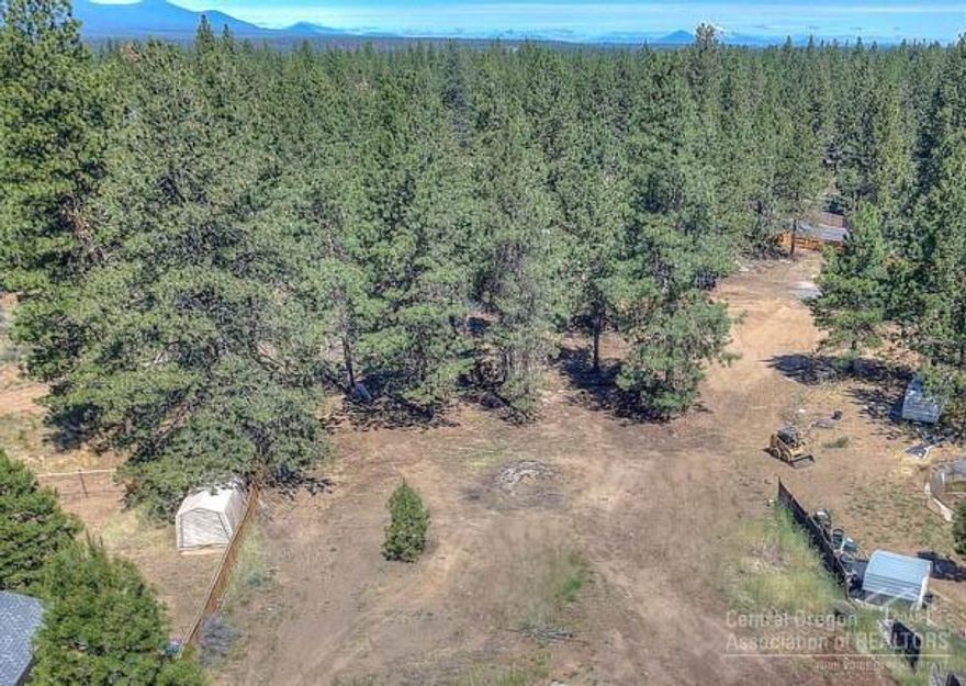 Elevated and buildable 1-acre lot in SW Bend. Great location off a paved road, with easy access to Hwy 97, but not close enough to hear from the lot. All utilities at the lot, including an older septic. Your chance to own one of the last vacant lots in Deschutes River Woods. Great place to get that ''out in the woods'' feel, but only minutes from all you need in Bend.