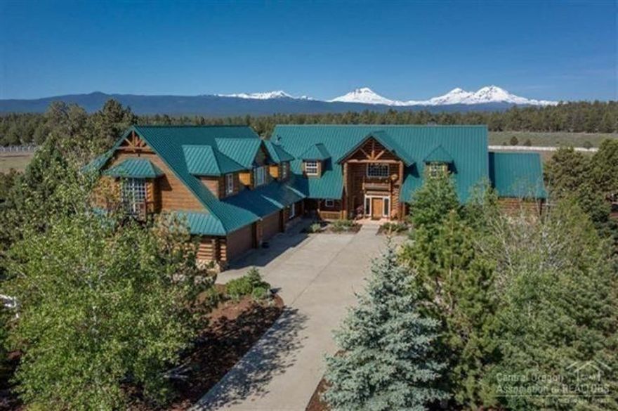 Natural style & beauty of the great outdoors is reflected in the interior design of this quintessential lodge styled Estate. The ultimate back drop of the Cascade Range sets the stage for the understated beauty in this grande home that reflects an organic, clean and simple style. Log timbers harvested from local forests, massive floor to ceiling Montana river rock fireplace featuring a natural twisted Juniper log mantel, slab granite. Escape to your home with a resort feel that fosters escape & relaxation