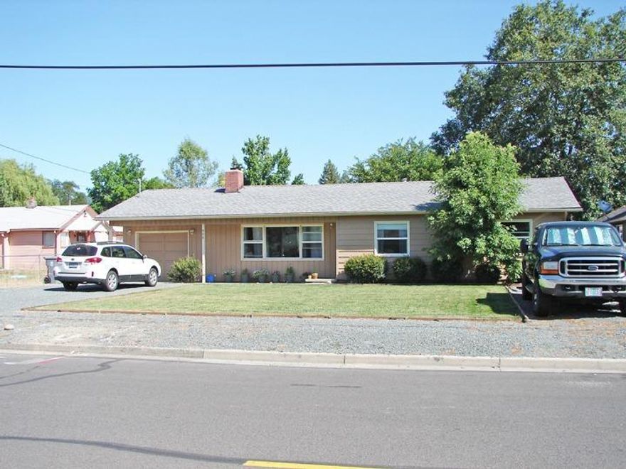 This family friendly SW Grants Pass home features 3 bedroom, 1 bath, a.23 acre lot, located close to schools, park and shopping. This home has newer exterior paint, double pane windows, RV or boat parking area, large Cedar fenced backyard, gardening area, sprinkler system, & large covered patio. As you walk into the front living room you will see the beautiful marble fireplace with oak mantle and large picture window. The kitchen offers oak cabinets, granite counter tops and lots of counter space and storage. This is a must see!