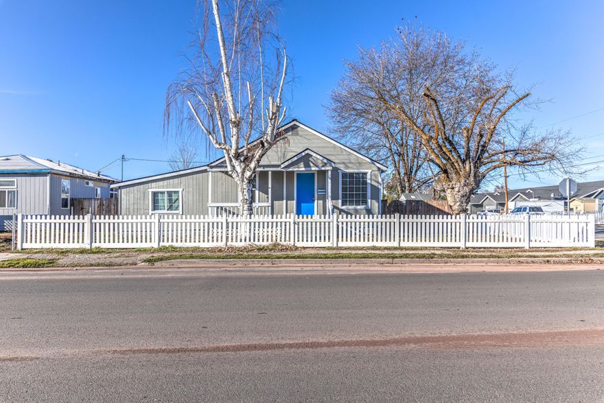 Adorable cottage style home in darling downtown Prineville.  This quaint 3-bedroom 2 bath home is on a corner lot in the highly sought-after downtown area.  This home has a new roof, well for irrigation, upgraded furnace, new flooring throughout, upgraded kitchen with new appliances, upgraded bathrooms.  Good sized laundry room with storage.  Pergola covers the back deck off the kitchen that looks over the fenced back yard with a cute fire pit for year-round entertaining.  Short term rental approved.  This darling home is centrally located and just minutes from parks, shopping, restaurants, hiking and biking trails This little gem won't last long! Welcome Home!