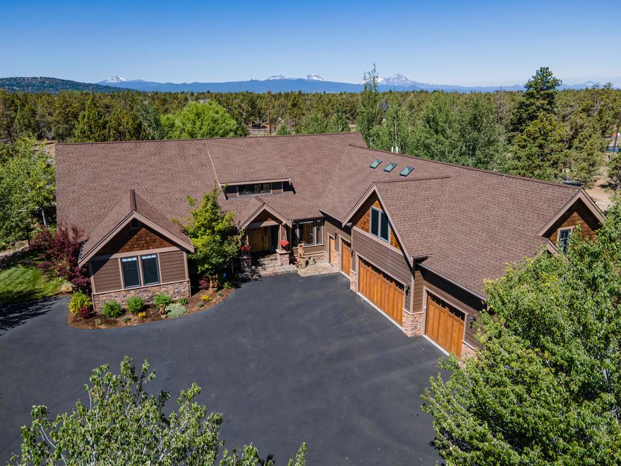 Rustic appeal on the canal, just 10 minutes from town. Many upgrades 
to the landscaping, tranquil water feature, gardens, dog run and fabulous outdoor living area! Great layout with single level living and an upstairs portion consisting of a massive bonus/game room, full bath and bedroom making a private living quarters above the 4-car garage. Spacious master suite + bathroom w/ stone + tile shower, ample storage plus a huge walk in closet.  2 secondary rooms have jack n' jill bath, closets with organizers, Pella windows, built-ins, entertaining kitchen with 3" granite slab island.  See list of other improvements.