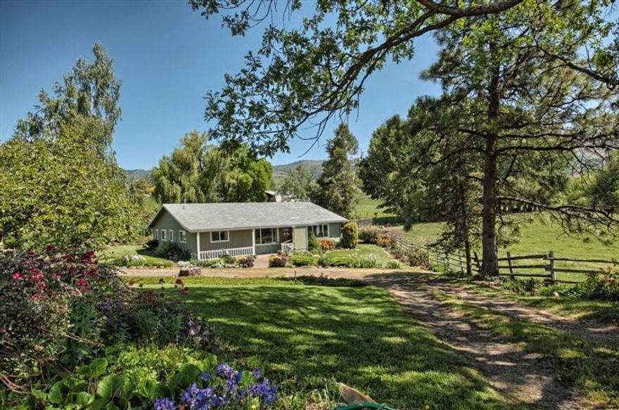 Spectacular setting near the end of a quiet country lane in the hills of Ashland, Oregon. Enjoy views of sweeping green pastures, Mt. Ashland and Pilot Rock! Currently a Working Ranch on almost 13 acres, TID flood irrigated and crossed fenced, currently supporting cattle (livestock could be purchased separately) with potential to lease adjoining 17 acres w/hay barn & corral and 22 acres for additional cattle and hay production. 3 filtering ponds and Myer Creek run through property. Solid detached barn with workshop holds 800+ bails. Add'l structures include fruit room/well house and chicken pen. Well pumps 14.3 gpm per recent flow test and supplies water to house and garden. Charming family home has been updated/remodeled over the years, 1842 sf, 3bd/2ba with living and family rooms, mud/laundry room off kitchen, central air & heat pump are electric with oil furnace. First time on the market, this well loved property has much to offer!!