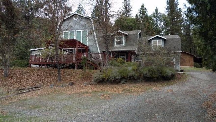 Very private home in beautiful area of Southwest Medford. Zoned WR (woodland resource), you'll find plenty of evergreens. Hardwood and tile floors, grand entry with soaring ceilings and impressive brick fireplace. Updated Kitchen with stainless steel 5 burner range/oven, granite counters and oak cabinets. Family room features floor to ceiling windows and home has plenty of storage.