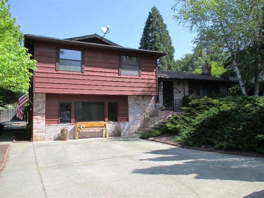 It's a wonderful life in the small town of Rogue River...This 1920 square foot tri-level home features at least three bedrooms and 3 baths, cozy living room with used brick hearth and fireplace and wonderful kitchen. The lower level will surprise you with a spacious living area which has endless possibilities a fourth bedroom, a family room or separate living quarters (with its own bath), private entrance and oh, so much storage behind louvered bi-fold doors. Out back, a detached double car garage, and the best part a large deck which includes a gazebo that shelters an outdoor eating area just steps from the kitchen. There's room for bonfires on the gravel and all the privacy you could want. Surrounding mountain views peek over the back fence AND there's also RV parking on the side of the property. Come take a look!