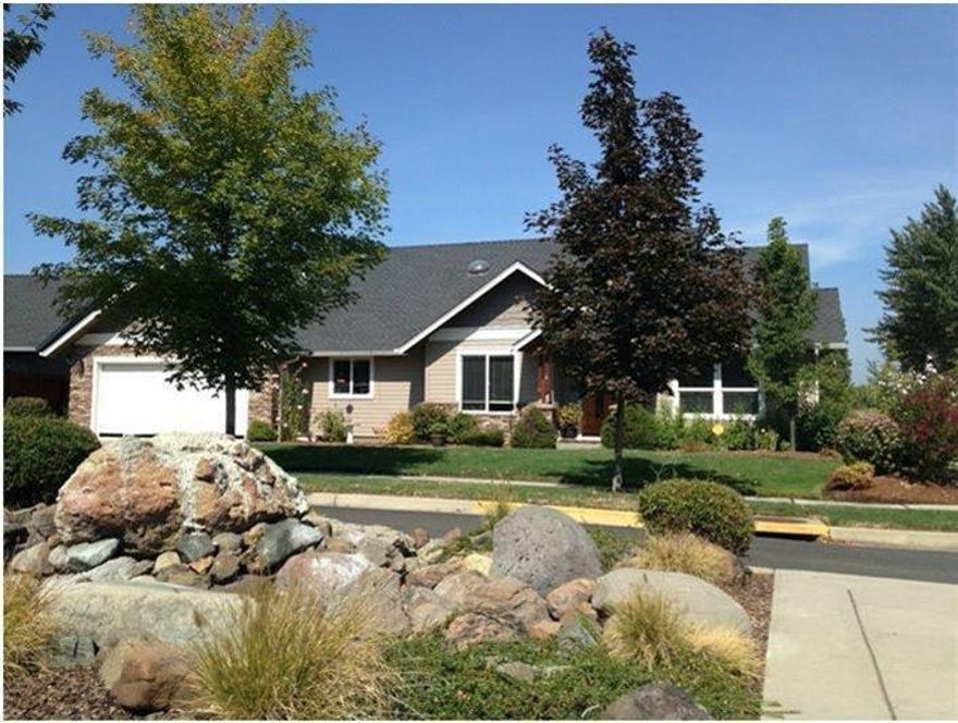 Charming rocked exterior trim and entry alcove lead to leaded glass entry door. Beautiful cherry laminate flooring, cherry kitchen cabinetry and vaulted ceilings create impactful impression upon entering. Open floor plan with breakfast bar, granite kitchen counter and stainless kitchen appliances. Living room w/solar tube and French doors opening to cozy patio. Split bedroom floor plan with master leading out to relaxing patio, private 2nd & 3rd bedrooms at opposite end. Master bath with jetted tub and large, separate shower. Finished and insulated over sized garage w/built in, custom storage cabinets. Seller owned alarm system. Owner may carry.