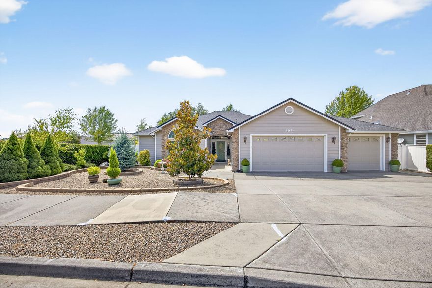 Beautiful 3 bed, 2.5 bath, 2066 SF home in Eagle Point with quality finishes and thoughtful upgrades. Spacious kitchen features granite counters, a large center island with pullout shelves, stainless steel appliances, wall oven, and smooth-top range. Formal dining plus cozy dinette. Split floor plan with vaulted ceilings, crown moldings, and architectural detail throughout. Primary suite offers recessed ceiling, walk-in closet, and tiled bath. Jack & Jill bedrooms up front, one with a walk-in closet. Enjoy comfort year-round with a brand-new HVAC and water heater (2024), ceiling fans, and an electric fireplace. Custom window coverings included (except drapes in primary). Tile flooring in kitchen, baths, and entry; plush carpet elsewhere. Oversized 3-car garage with Capp Concrete coating and L-shaped workbench. Low-maintenance yards. HOA $144/year. A move-in-ready gem with style, space, and function!