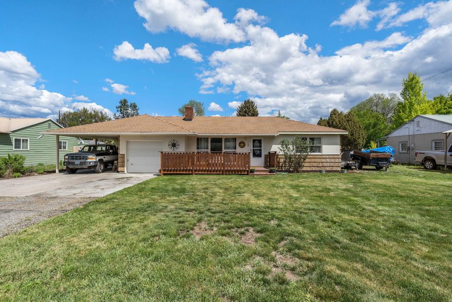 Charming 1955 Ranch style cottage in great neighborhood near the fairgrounds. Home is light and bright with vinyl windows and freshly painted throughout. Living room
with brick surround pellet stove and mantel. Updated natural gas heating and cooling system. Kitchen has solid wood cabinets, laminate counters, & tile backsplash.
Laundry/mudroom off the kitchen has built in storage & utility sink. Two good sized bedrooms and large primary suite with dual closets and big windows. Bathroom is
located between the bedrooms and has been re-done with new cabinetry, double sinks and large/tub combo. Outside is a covered patio for entertaining, large yard with
newer fencing. Backs up to alley with gate for access. Room for RV/Boat storage under covered carport or on other side of house. Single, attached garage for additional
storage as well as small storage shed on back of carport. Great location just a short walk to the fairgrounds for all the summer festivities! Close to schools.