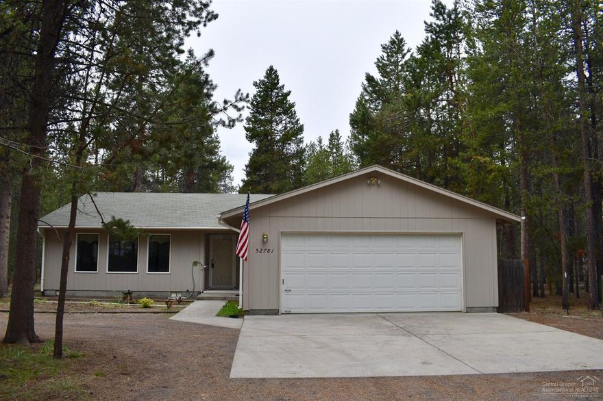 Charming and move-in-ready 3 bedroom, 2 bathroom, 1,704 square foot single level home settled in among the pine trees. Sliding glass door in the dining area leads to a wood deck off the back - perfect for enjoying your morning cup of coffee or for dinner with family and friends! Insulated 2 car garage with work benches. Yard is landscaped with native plants and trees, has a small fenced pet area with dog door, 1 set of Full RV hookups and a circular driveway. Located close to Highway access and BLM located at the end of this dead-end street. Don't miss this opportunity to own a Stick Built Home at a GREAT price!