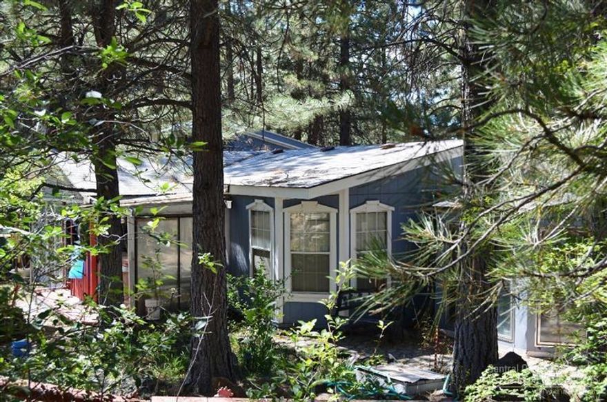 Privacy plus on .98 Acres. Nice 3 Bd 2Ba manufactured home with additional Guest House and Game room. Water Feature and multiple out buildings. Large Pantry and sun porch off the back and covered front porch. Open Bright Kitchen with lots of Storage. Bonus Craft/ Hobby Room. Multiple Fruit trees and walking path around water feature and rock outcropping.