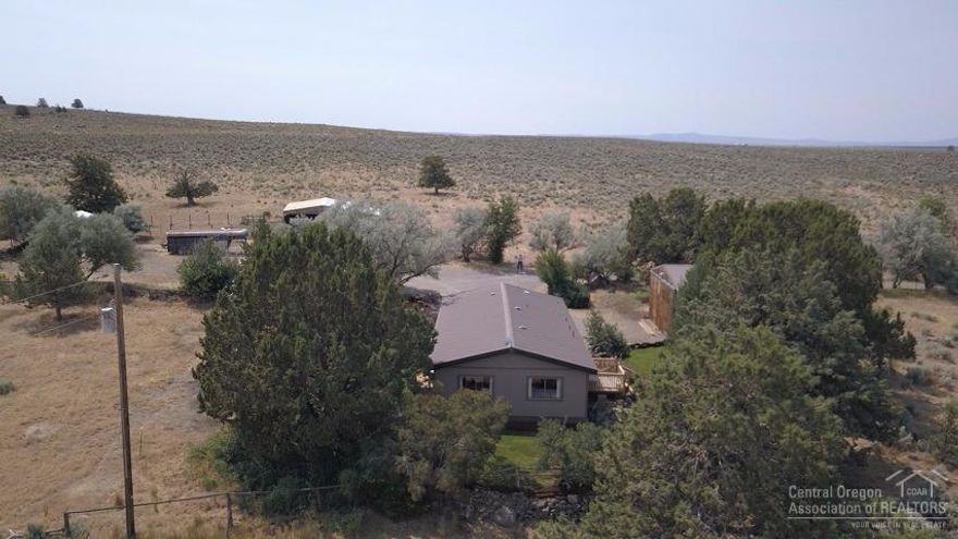 Do you want a view? Come to this 159 ac.Oasis in the desert. Sit in te shade & enjoy the beautiful sunrises & sunsets,nature,wildlife & more.This property has a 2br/2ba mfg. home,2car garage w/shop area,2-stall barn w/a feeding area,corral,fenced/cross fenced acreage.Nicely landscaped yard w/many trees & shrubs(treed driveway too).About 60 ac. to north wcrested wheat for your animals.Beautiful views of the valley below & distant mountains while you enjoy the solitude of this property at the end of the road.