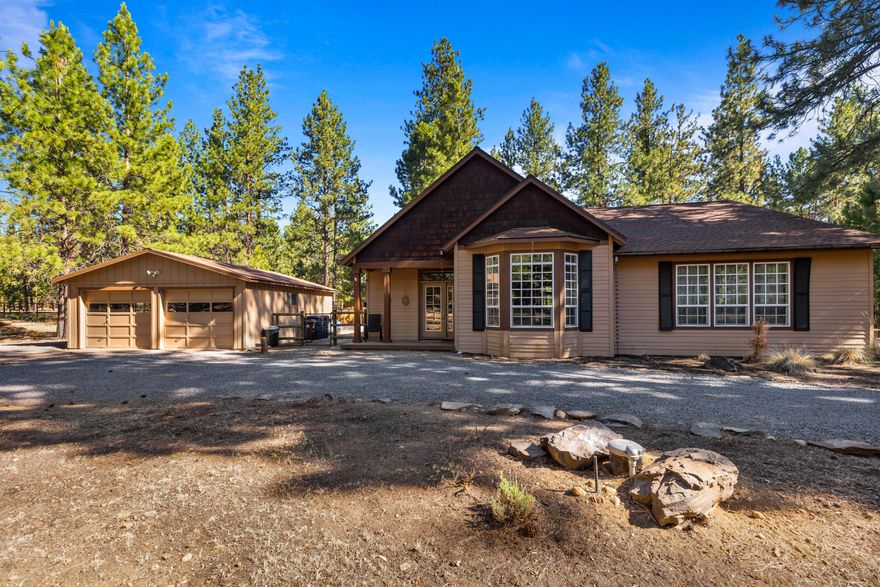 Welcome to this stunning single-level home nestled in the tranquil crossroads community, just minutes away from downtown Sisters and Black Butte Ranch. Just shy of an acre, this multi-generation property boasts a spacious layout with  an oversized bonus/flex room, perfect for a home office or fourth bedroom. The primary suite features vaulted ceilings and floor-to-ceiling views of the surrounding trees, offering a captivating experience of living in the heart of Central Oregon. Outside, the fully fenced backyard with direct access to public trails provides abundant space for activities and year-round entertaining. The detached two-car garage includes a large shop area and a storage shed for tools and toys. With natural light flooding in, updated stainless steel appliances, and a beautiful floor plan, this home is not to be missed. The perfect oasis to make your new home or vacation getaway. Recent 2024 updates include new carpeting and new interior paint.