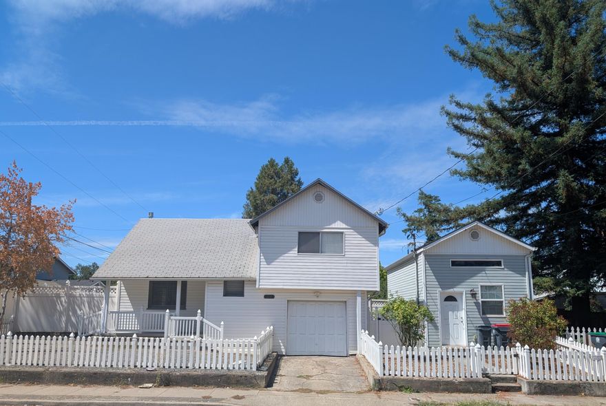 This property is amazing and is a very rare find. Two family set up or rental investment opportunity. The main home is 1229 sq. ft and features 3 bedrooms and 1 112 bathrooms. Large living area with kitchen that has newer flooring. Single car attached garage. Nice fenced side yard that Is secure, The second house was built In 2004 and has high ceilings and newer appliances. It is a studio, Jackson county shows 402 sq. ft but past sales show 526 sq. ft. It is currently being rented. The main home hag a sitting porch and both properties have a white picket fence.