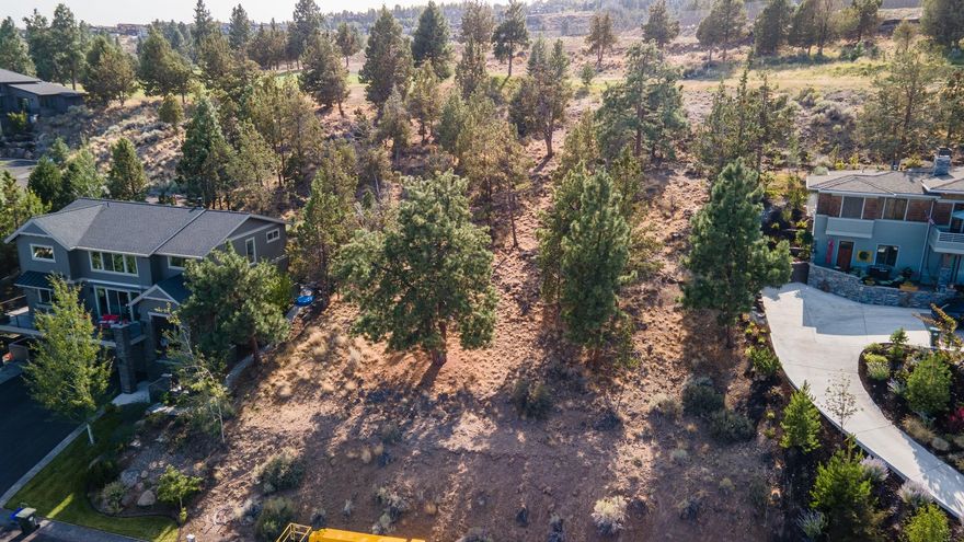 Spacious lot providing elevated easterly views of beautiful Bend. This property is located in one of Bend's most desirable neighborhoods, River's Edge Village, on Awbrey Butte. Enjoy proximity to golf, river, hiking trails, and shopping in this neighborhood of high-end homes. Grab your builder and build your dream home on this fabulous 0.43 acre lot.