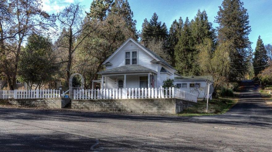 Charming historic home located within walking distance to downtown Jacksonville and Britt Gardens. Originally built by Mr. Frick who started the town mercantile and sat on the City Council. This lovely Victorian home has recently been enhanced with some assorted tasteful updates including new granite counters, tile baths, laminate flooring and more! The main home includes 2211 sf of living space with a large bdr, 1 bath on the main level and 2 bdrs, 1 bath upstairs. The home also boasts an inviting living room and dining area with a centrally located fireplace. The kitchen features updated appliances, new granite counters and a cute breakfast nook area surrounded by windows providing plenty of natural light and relaxing ambiance. Other features include the recent addition of an attached 375 sf 1 bdr, 1 bath guest cottage that includes a Jetted tub and ductless heat/air. Situated on a level corner lot that includes a detached over-sized 2 car garage plus room for on-site RV pkg.