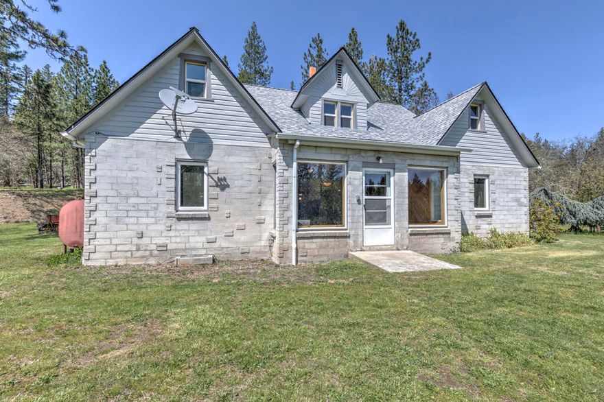 Your new home is quiet and peaceful with end of the road seclusion while close to town. 58 acres with 1500+ ft of Sucker Creek frontage! Quality built and updated traditionally styled stone 2,225 sq ft home.  Entertain family and friends with hiking, camping, swimming in your creek swimming hole and more, while never leaving home.
Expansive views of the orchard, meadow and forest.  Entry into the bright living room, open beam construction and double glass doors to the patio and the above ground pool. Kitchen has high quality cabinetry with wood sourced from the property, roll out shelves and a kitchen island with a propane cooktop.  Remodeled 400 sq ft attic with knotty pine walls and ceilings that pop with the light of the 8 dormer windows. 3 bd on the main floor with hardwood floors. Large windows in the front living room. Whole house 200 AMP generator with automatic start. Basement for storage, separate outbuilding for storage/freezer room, a shop and a tall pole barn. New 2021 Roof
