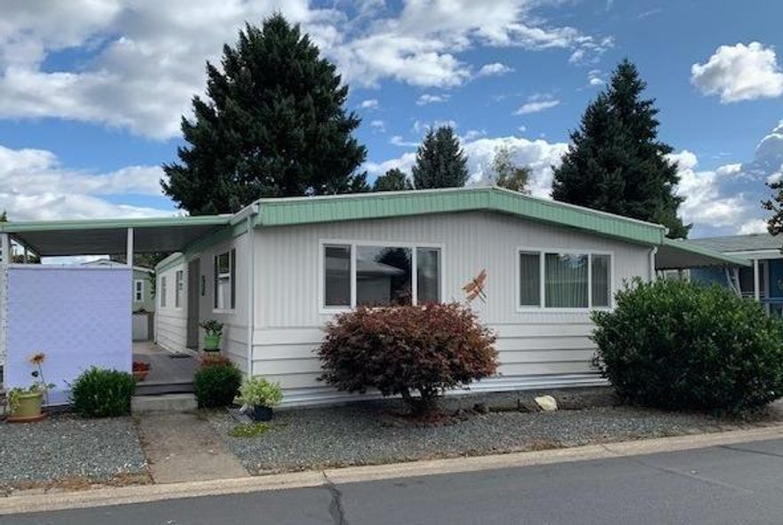 Open for admiration! This 2 bedroom 2 bath home is located in desirable Glenwood Mobile Estates, a 55+ park. Recently remodeled with laminate floors, new windows, faucets, kitchen sink, fans, & new lights throughout. You'll love the gas cooktop in the kitchen. A pantry, lots of cabinets & counters make meal prep simple. Appliances stay too. Vinyl floors in the kitchen, bathrooms & dining room. The windows come with vertical blinds throughout. The master bathroom has a luxury walk-in shower with glass doors. The master bedroom opens onto a covered patio in the private backyard. Here the yard is graveled instead of lawn for easy care with sprinklers for shrubs & trees. The backyard has blueberries, apple, pear & grapes and views of the open space. Freshly painted inside & power washed outside. In addition to the back porch, a covered side patio is inviting & sunny. Two sheds for extra storage. A peaceful location close to the mailboxes, clubhouse & pool.