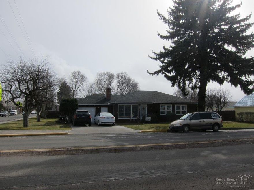 Situated on 3 city lots this well cared for home is truly a classic! Pride of ownership is obvious. Home has been updated throughout from the refinished original hardwood floors to the bathrooms & kitchen. Cozy front room with wood fireplace & brick surround & large family room with a gas fireplace & built-in cabinets. Updated kitchen & bath. Large bedrooms with built-ins. Enjoy the private backyard with 2 separate patios, hot tub, gazebo & seasonal flowers. Room for a big garden or your RV & toys.