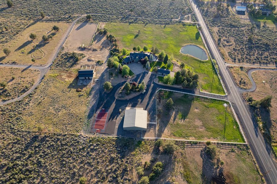 Your exquisite 3,488 sq ft custom built estate sits perfectly upon 10 private acres minutes from Bend. The main home offers elegance in the country. Follow the stone stacked grand entry into the main level living, where you can find vaulted wood accent ceilings, stunning Cascade Mountain views and a gas fire place. The open floor plan is anchored by a breath-taking kitchen equipped with thickened chiseled edge granite countertops, two sinks, a six-burner stove top, and a big walk-in pantry. On the main level you will also find a large office, and the spacious master bedroom. Upstairs there are two bedrooms and a large bonus area.
Outside you can find a 2-bedroom bunk house, 5 stall barn, tennis/basketball court, team roping arena, and a 3,120 sq ft shop equipped with a boat room, half bath, and wet bar. All irrigation is underground and set on a timer. 
This one of a kind property could not be any more turn key!