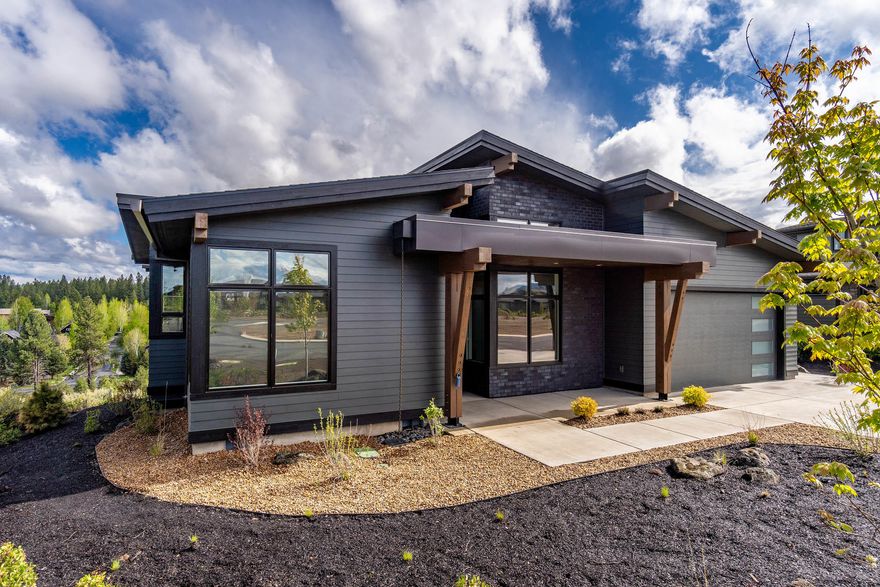 This newly completed single-level NW Contemporary home by Simplicity Homes is a bright, contemporary retreat on the high plateau at Tetherow Resort. From the moment you enter, you'll notice the high ceilings w/ skylights, tall windows & doors, & clean lines throughout. The sunny, south-facing great rm features a gas FP & oversized windows overlooking the common area behind the home. The well-appointed kitchen opens to grt room & dining area, & features a lrg island w/ breakfast bar, white cabinetry, white quartzite counters, & high-end SS applc pkg. Open the glass sliders off the dining area to the pavered patio for easy indoor-outdoor entertaining. Enjoy great separation of bedrooms w/ 3 BD & a lrg BA off the front hallway, & the Master tucked into the back corner, featuring patio access & a spa-like bathroom w/ soaking tub, tiled w/i shower, double vanities, & access to the huge w/i closet. Rounding out the home, find a large mudroom/laundry room off the two-car garage.