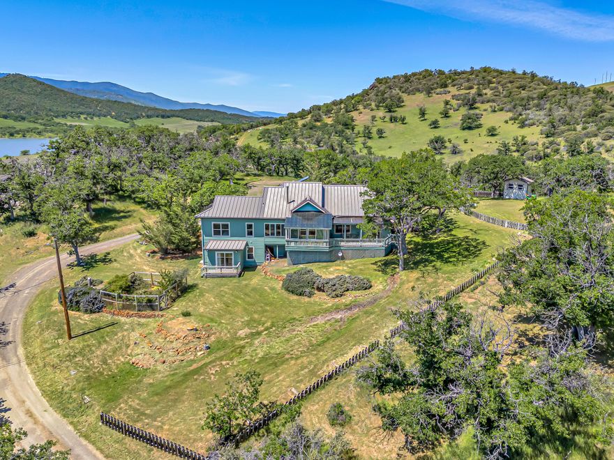 Enjoy breathtaking views of Emigrant Lake and surrounding mountains from this custom 5BR/4BA home set on 20 EFU-zoned acres, just 15 minutes from downtown Ashland. The versatile floor plan boasts a main-level primary suite, vaulted ceilings, solid oak floors, and a cozy wood stove. The sunlit kitchen with granite countertops flows into the formal dining room and vaulted living room with walls of windows. A separate-entrance lower level offers ideal multi-generational living. This home offers energy-efficient living;  a strong producing well with filtration system (buyer to do their own due-diligence), and a ''smart'' 3-zone HVAC system. Additional improvements include an 85-gallon water heater, dual septic systems, a metal roof, fresh interior and exterior paint, and durable concrete composite siding. Unwind on the screened porch or expansive decks and feel like you're in your own private retreat!