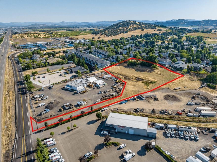 Build your home with beautiful city views and have your business next door.  Commercial zoning allows for single family residence in conjunction with a business.  Two accesses available.  Build your view home with access off of Skyhawk Ridge, and have access to your business from Crater Lake Ave.  Heavy Commercial Zoning allows for large variety of business including RV Park, Storage, Multi Family, and much more.  May be possible to rezone to residential if preferred.  Priced to sell.