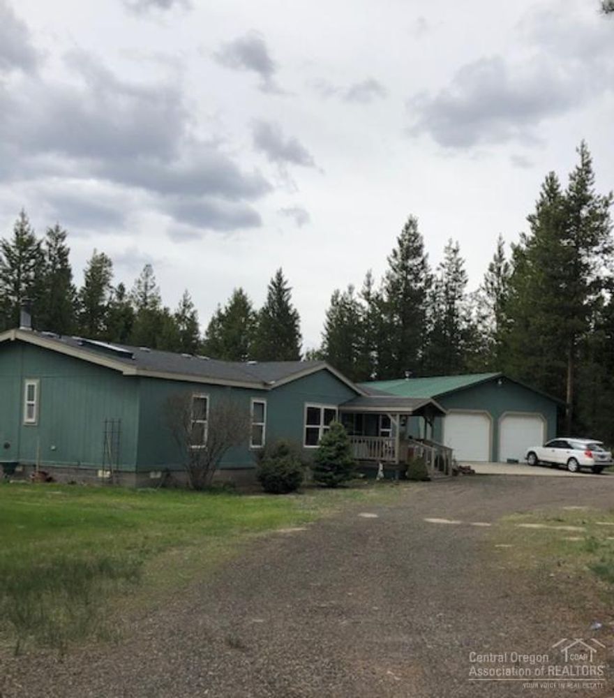 Wow! This is a great property. Located on 1.88 acre corner lot on paved county maintained road.Large shop attached on the back on the double car garage.Large covered deck w/large patio down below. What a wonderful area for entertainment. Huge back yard. Garden building, Covered RV parking.Home has been updated w/new Waterproof laminate flooring,new tile shower and bathroom countertops. Custom cabinets, lg Pantry, breakfast bar.Large family room off kitchen for a superb entertainment area. Master bedroom features His & Her mirrored closets Master bath features privacy toilet, Double sinks and tiled shower. The other 2 bedrooms are large with walk-in closets. Guest bath has a soaking bathtub. Vaulted living room is light and airy. There is so many storage closets and cabinets. The subdivision it sits in has a Golf Course, clubhouse and a river running through it. No HOA. Beautiful area.This home you have to see to appreciate so call today for a showing