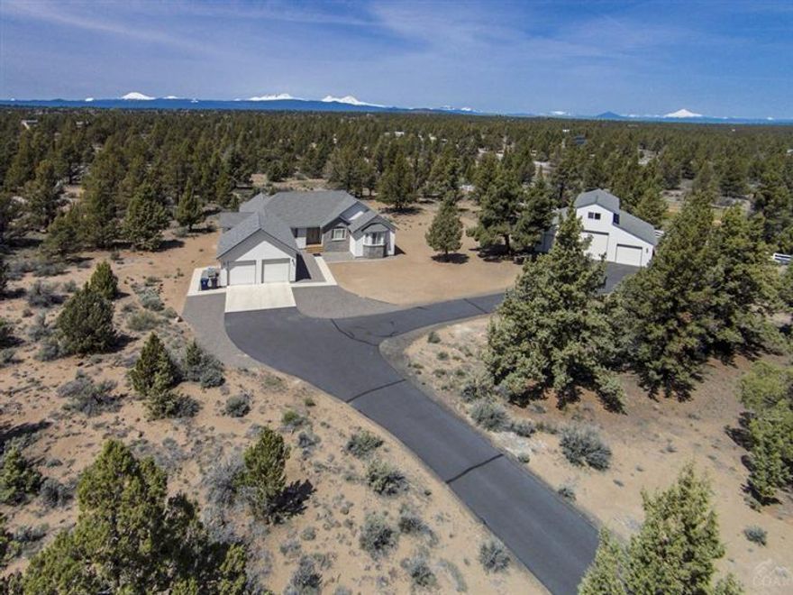 Custom Home & Shop on Private 5 Acres W/Great Cascade Views! Perfect 4bd/3.5ba features: great room w/granite gas FP, Big mtn views, B-Nook & HW floors, open kitchen w/alder cabs, granite counters & center island, Big master w/dbl doors, bay window, slider to deck, bath w/tiled vanity & floors, soaking tub & sep shower, covered front porch & wrap around viewing back deck, Propane gas heated 45x40 shop w/tiled full bath, 3bays & side deck + finished 400+sf man-cave bonus above, and 1yr Home Warranty too!