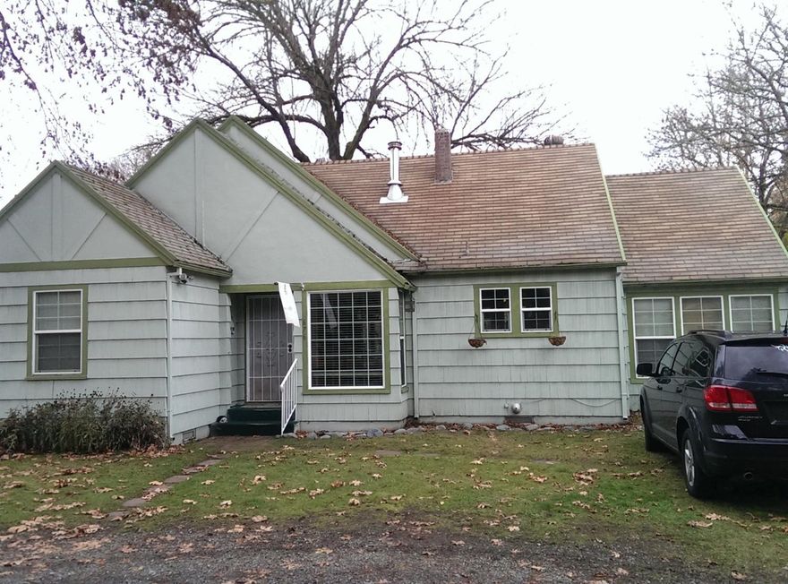 Beautiful .37 acre lot in SE Grants Pass. This 1133 sq ft home has three bedrooms and a single bath. The flooring and interior paint is only two years old. Double paned vinyl windows throughout. It has a beautiful green lawn and a very well established (1973) grape arbor/vineyard and a garden area. This great property has been owned by the same family since 1976. Well pump was replaced in 2012.