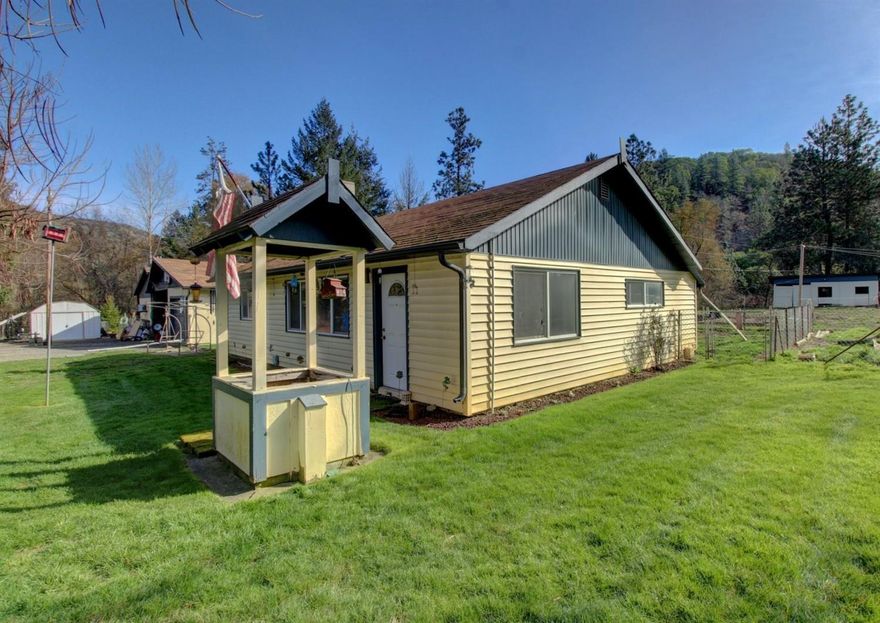 Inviting country homestead on a year-round creek! Looking for a property for your horses or looking for that property both with outbuildings and plenty of useable land? Look here! Charming home; detached garage; shop approximately 14'x24'; barn with 2 horse stalls, tack room, and pig pen; various outbuildings; fully fenced property with two gated entrances; and parking galore! 2.33 useable acres, irrigation for 1 acre from GHID via in-ground sprinkler system. Home features updated in 2006- heat pump, vinyl windows, exterior and interior doors, and flooring. Make an appt. to view in-person today!