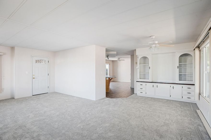 Move in ready! Spacious home  with new laminate wood floors, new carpet, large kitchen with island, beautiful built in cabinetry in living room, Jack-n-Jill bathroom, two walk in showers, and a covered porch. This home is located in a desirable park with two ponds, close to the river, a clubhouse with a library, game room, and an event hall! Schedule a showing today! Seller to pay three months land lease with acceptable offer!