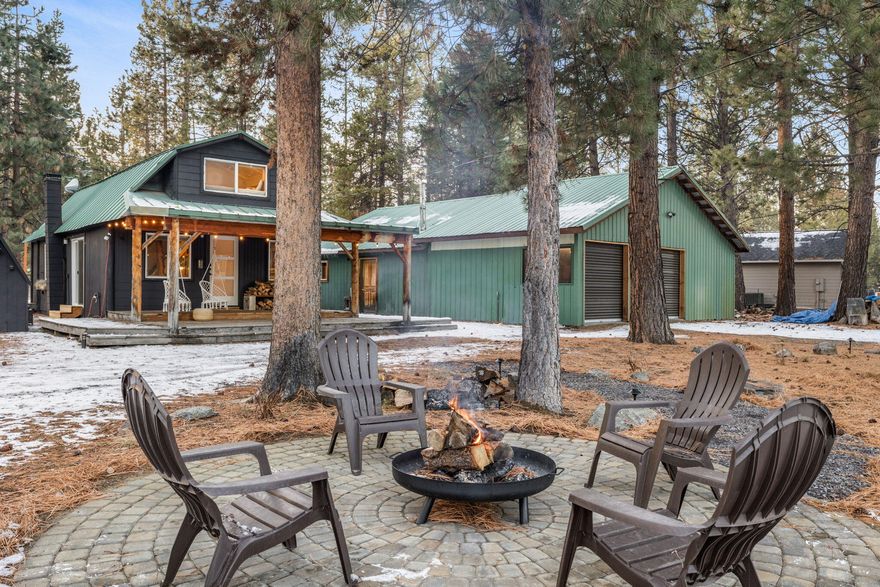 ADORABLE Bungalo with charming upgrades, new mini split (heat pump), Newly fenced and extra large patio with a hot tub for those star gazing relaxation evenings. This fully gated semi circle driveway oasis with a private paver patio and fire pit, beautifully xeriscape yard with wifi sprinklers is perfect for your Central Oregon Adventures and nesting in the comfort of this beautifully treed property. The 1232 sq foot shop with new automatic roll up doors has everything you would desire in your hobby area including an office, full bathroom and activity room. You will also enjoy the storage space available in the 96 sq ft shed. The uniqueness of this custom woodworking home is like a fantasy of expertise. Blue and Buggy barn doors and accents, food grade Concrete kitchen counters, cozy wood burning fireplace, ghost tree accents inside and out that add to the elegance of the artistic touches of the owners. This is an Oasis you will want to call home!