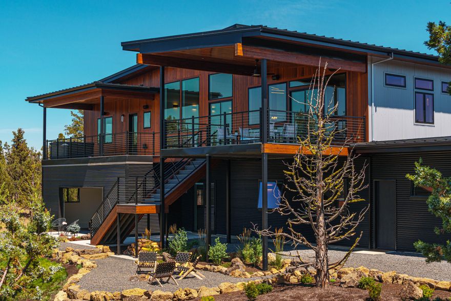 Phenomenal NW Contemporary located on 19 acres on Bend's coveted Westside. An unparalleled setting overlooking the Cascade Mountains and High Desert landscape, this property captures an exquisite artful design throughout, complete privacy, and solar system for maximum energy efficient living. Light-filled Great Room features soaring ceilings, dramatic beam work and massive windows blending indoor/outdoor living seamlessly. Inspiring chef's kitchen with stunning expanse of honed granite counters, prof'l grade appliances and an entertainer's dream butler pantry. Extensive covered back deck ideal for taking in the tranquil setting or entertaining al fresco. Primary Suite with Cascade views and luxurious spa-like bath. 3 add'l BR/full BA, home office + add'l flex space on main level. Lower level: 2 BR, in-law suite, elevator and fabulous 25 yd/3 lane saltwater pool. 4 car garage. Experience the Bend lifestyle from your own private oasis just minutes to all Westside amenities.