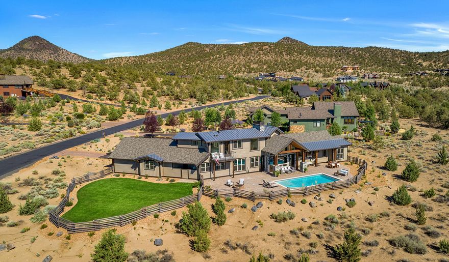 HUGE 1.34 ACRE DOUBLE LOT W/ UNOBSTRUCTED PROTECTED CASCADE MTN VIEWS! A thoughtfully designed custom home w/ 30 ft heated pool in the sought after neighborhood of Brasada Ranch. 18 ft ceilings, gourmet kitchen w/ Professional M-Series Wolf double oven & cooktop, Bosch & Thermador appliances, wine bar & cellar, natural knotty alder cabinets, granite, & quartz counters w/ marble backsplash & large island for entertaining! Exquisite primary suite w/ private deck, fireplace, & complemented by a beautiful bath, marble counters & tile, heated flooring, jacuzzi tub, & programmable shower. Excellent separation w/ 2 additional bdrms & bths, a wonderful MOVIE room/4th bdrm w/ motorized movie screen & Dolby Atmos 12-speaker system. Could be sold ''FURNISHED''. Oversized 3 car garage, an expansive patio w/ gas fire pit, and an additional fenced yard and private estate lot setting w many possibilities, excellent for pets, family fun, and entertainment!