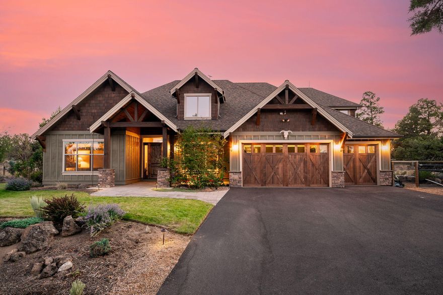 Experience the serenity of this remarkable 4+ bedroom home set on a picturesque 11.8 acre lot just 10 minutes from town. A private paved driveway welcomes you to this breathtaking residence bordered by BLM land. Step inside the vaulted great room with stone fireplace + custom knotty alder cabinetry. The main floor hosts most of the living space, including luxurious primary suite featuring a wall of knotty alder cabinetry, a spa-like bathroom with a soaking tub and steam shower + a spacious walk-in closet. French doors open from the primary suite to a backyard paradise, fully fenced yard; natural swimming pond, waterfall, sandy beach + immaculate landscaping.  The 2nd floor has a bonus room (5th bed) + large family room w/ 2 queen murphy beds. Enjoy outdoor living with large covered patio, fire pit, dual sound systems + a dedicated play area. There's a fenced area for animals, shed + coop, powered utility shed + ample space to further develop. Expand the vision + make your dream home!