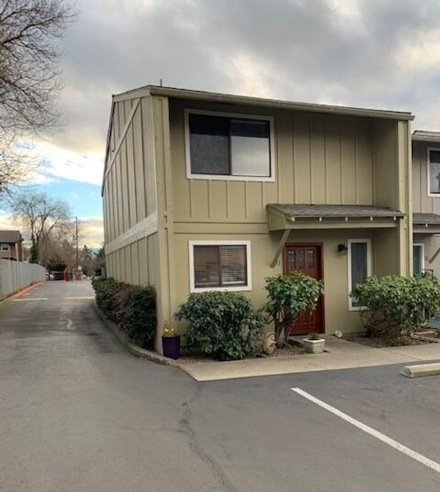 Why pay rent? Make your payments count. You can afford to own this condo.  This end unit features a U-shaped kitchen with abundant tiled counters, a new dishwasher & garbage disposal.  A brick surround for the pellet stove and sliding doors to the patio highlight the long living room. A half bath and storage under the stairs round out the first floor. Durability and easy maintenance are the key words for the rich laminate floors throughout the first floor. The upstairs has a main bedroom with ceiling fan, sliders to the deck, a walk-in closet, and a door to the Jack & Jill bath. A laundry area in the large landing area is convenient to both bedrooms. The heat pump & water heater were replaced in May 2021. Electricity runs about $70/mo for this owner. If you want to be near groceries, shopping, restaurants, bus line & the hospital, this location will suit you well. Good things do come in small packages. This is one of them and the price is right too.