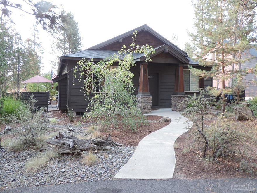 Beautiful naturally landscaped yard & uber clean home in private neighborhood near the clubhouse/fitness room, outdoor sport court & miles of trails, but close to town & schools. Perfect for a plush vacation home base or full time resident who doesn't need a large home. Enclosed patio, gas fireplace w/hearth & mantle, hickory hardwood & cabinets. A/C! 3 garden beds w/sprinklers! City water/sewer, natural gas heat & HW, paved & maintained roads. Off road public lands nearby to bike & run the pooch!