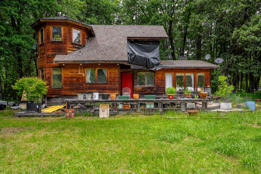 Welcome to nature's retreat! At the heart of this property sits a 1,479 Sq Ft timber framed home, exuding rustic elegance with T&G pine ceilings & exposed wood beams! Wood stove for heat & ambiance. Detached living space with potential for family, guests, or rental income. Attached to the living space is additional storage. The 3,500+ Sq Ft AG building/shop is perfect for housing equipment, vehicles, or hobbies! Property includes 11.8 acres of RR5 zoned land, offering potential for another home. Over 5 acres of meadows provide plenty of room to farm, garden, and more. A stately redwood tree adds a majestic touch to the landscape, while the surrounded wooded areas offer peace & privacy from neighbors. Enjoy the tranquility of Indian Creek, while also using irrigation rights. Previous farming did not use pesticides. Domestic water comes from a spring/cistern. Pond is great for irrigation & wildlife, including fish & birds. Near BLM! Owner carry with 50% down. Open to creative offers!