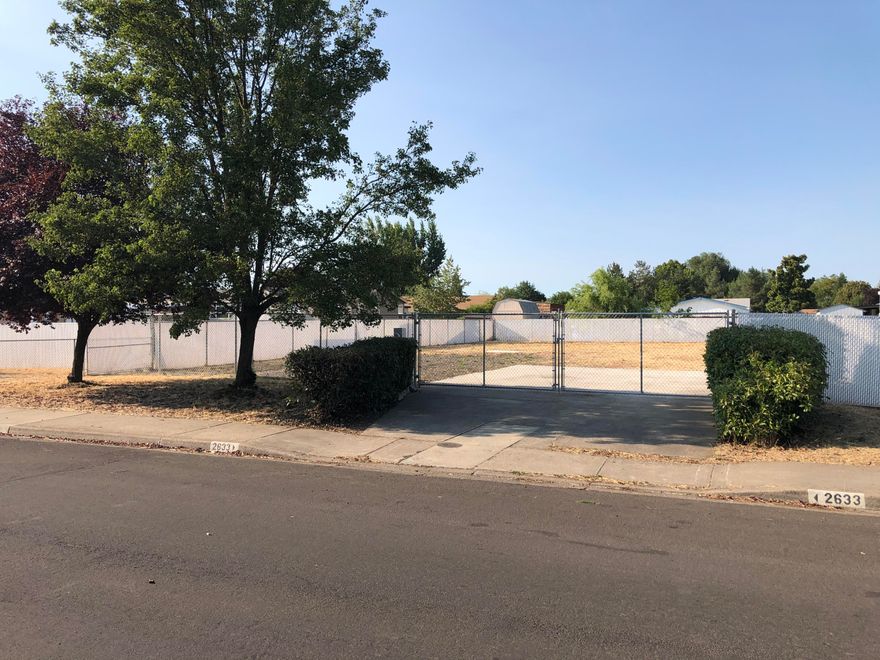 Fully developed lot ready for its new home!
This large 0.23 acre lot previously had a manufactured home on it that was sold and moved; that means the lot is already fully prepped! Simply bring in your own new manufactured home and place it on the existing pad, or with just a little development you can start construction on a new frame-built home. All utilities are already on the property, the driveway is already poured,
and the whole thing is fully fenced. The front portion has charming landscaping with trees and hedges for privacy, and the rest has been completely cleared for you to start on your dream yard. Here's a chance to transform this blank slate into whatever your heart desires.