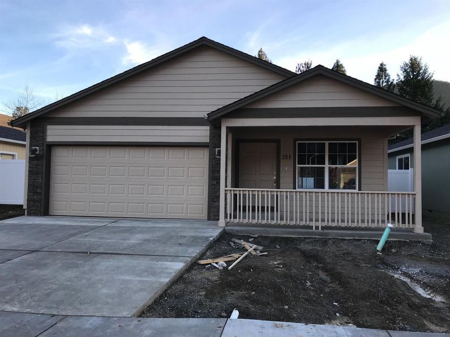 One of the last 7 homes left! New construction in Rogue River: 3-bedroom/2-bath detached single-family home built by Lori Magel Homes, conveniently located 15 minutes from downtown Grants Pass and 25 minutes from downtown Medford. This single-story home features vaulted ceiling, 4-inch plank flooring and carpeting, and ceramic tile flooring in both bathrooms and laundry. Kitchen features upgraded cabinets, granite counters, plank flooring, and upgraded stainless-steel appliances. The 2-car attached garage is fully finished and painted, with garage door opener. Vinyl fencing with gate for back and side yards included. Homeowners association to protect values with a monthly fee of $25.00. Move-in estimated 12/22/2017. Compare quality and value to any other new construction in Southern Oregon.