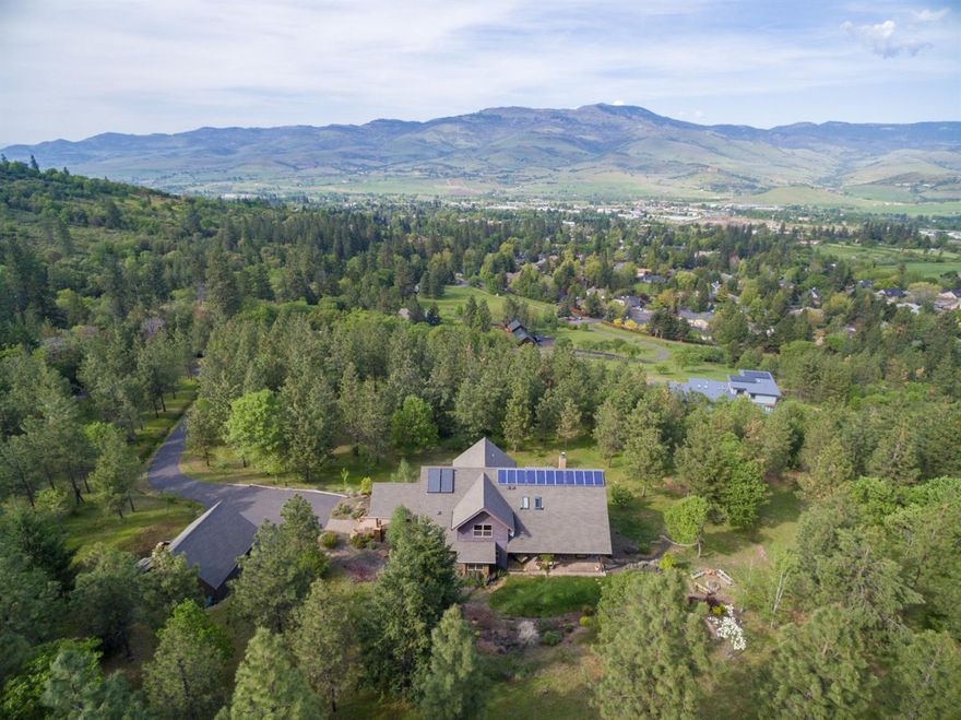 Custom built Earth Advantage Platinum home situated on 10 gorgeous acres just a stone's throw to the city limits. Surrounded by trails & city owned property, you're sure to love the convenience & privacy. Incredible Grizzly Peak & valley views. Efficient & sought after Geothermal heating/cooling + solar panels that heat the water & generate power for the home. Wild turkeys, deer and all kinds of Oregon wildlife roam the property. There is an acre of TID irrigation rights and a large enclosed organic garden area with an orchard of various fruit trees, mature trees & shrubs plus a pond. There's also a charming and quaint spa/pool combo and nearby firepit. Main level living includes primary master suite, vaulted great room, gourmet kitchen, formal/informal dining and lots of natural light, and Oregon Myrtlewood floors. Wrap around deck and cozy front porch. Versatile floorplan. Lower level would convert nicely into a guest apartment and has interior and exterior access. Detached garage.