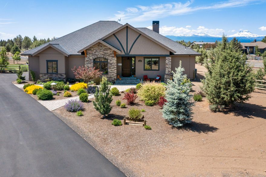 PRICE IMPROVEMENT! Motivated! This one-of-a-kind Sisters equine retreat  w/amazing mountain views, custom single level home & state of the art stable/barn, offers every luxury & attention to detail. 3 bedrooms/2 bath w/beautiful wood burning fireplace in great room w/vaulted ceilings & open floorplan. Spacious bathrooms w/heated floors & soaker tub in primary. Walk in closets & large floor to ceiling windows throughout the home to bring the mountain views in. Oversized covered paver back patio to enjoy the beautiful sunsets, gardens & firepit. Situated on just under 4 acres & tucked away in the desirable Desert Sand community, 7 minutes to Sisters. Mature landscaping, riding arena,2 large paddocks, 3/stall barn w/heated tack room w/bathroom. Pull through RV/shop & Barn. Video surveillance for livestock protection. Rubber matted floors & heated waterers. Property is completely fenced. Tons of storage for hay & equipment. Too Much to list! An absolute must see, book your viewing today