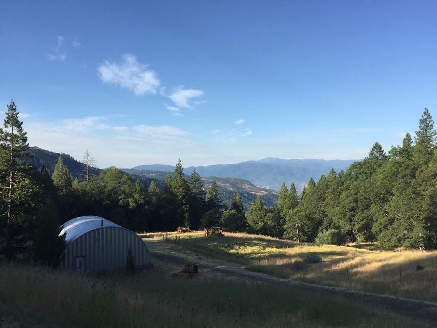 20+ Acres . A  couple of level areas but mostly rolling land with a million dollar view of mountains and a part of Ashland. Shop set up with concrete floor, and some other old structures- old cabin needs to be refurbished or totally removed and new built. Beautiful flag stone walk way - Extra building used for storage . No well or septic. Used to have power but a fallen tree cut the line the company pulled the box. Easement to get to the property but once there - no one uses it to go beyond.