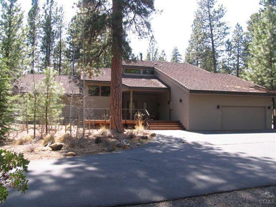 Home on lrg homesite bordering USFS & close to Glaze Meadow Rec Ctr. Recently remodeled kitchen w/gas range, sub-zero refrigerator, trash compactor, pantry & granite counter tops. 2 master suites & family game room. 2 propane stoves-1 in dining room & 1 in downstairs master. 1 fireplace in living room. Enjoy the view to the forest from the deck & hot tub or from upstairs enclosed sunroom balcony. Att 2-car garage & det 3-car plus RV garage. One of the most private settings in Black Butte Ranch.