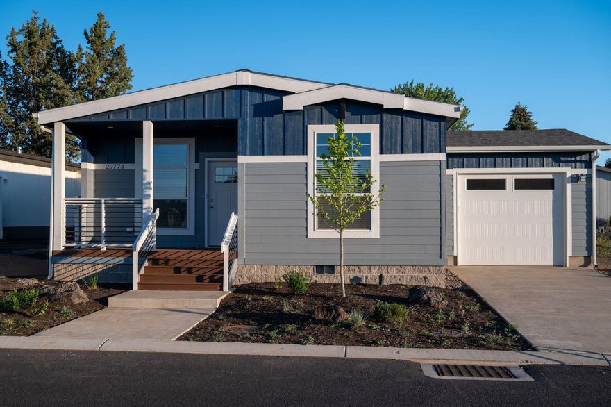 Introducing a stunning residence seamlessly blending modern amenities with timeless elegance. Featuring striking 9' ceilings, this Summit Loop model exudes timeless elegance. Central A/C ensures year-round comfort. Step inside to a chef's dream kitchen, complete with a stainless steel appliance package with a charming farmhouse sink. Gray overhead and base cabinets, equipped with soft-close drawer guides and hinges, offer both style and functionality. Designed for energy efficiency, this is Energy Star rated. The black pearl granite countertops emanate sophistication and style. Retreat to the primary bath is a luxurious retreat, featuring a walk-in shower and soaking tub. Additional highlights include a paddle fan in the living room and pendant lights over the kitchen island, perfect for entertaining. This home is a perfect blend of comfort, style, and efficiency, making it the ideal sanctuary for modern living.
