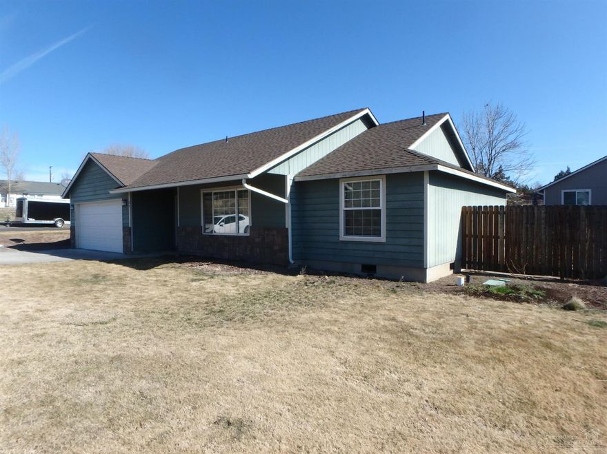 This home built in 2005 has over 1,243 sq. ft. on a large lot allowing you room to store the RV and your boat or utility trailer. No need to wedge them in tight, plenty of room in extra lot area. With 3 bedrooms and 2 baths, double car garage this home is perfect for a family, retires or rental. Located next to parks, trails and close to Aquatic Center, COCC & schools. The home is currently in the process of new carpet, plank vinyl flooring, range and painting inside / out, you will have a home like new. Located in quiet neighborhood with limited traffic and large corner lot, this is one you need to check out. Landscaped front and backyard, fenced. Estimated remodel finish date is April 20, 2020 +/-.