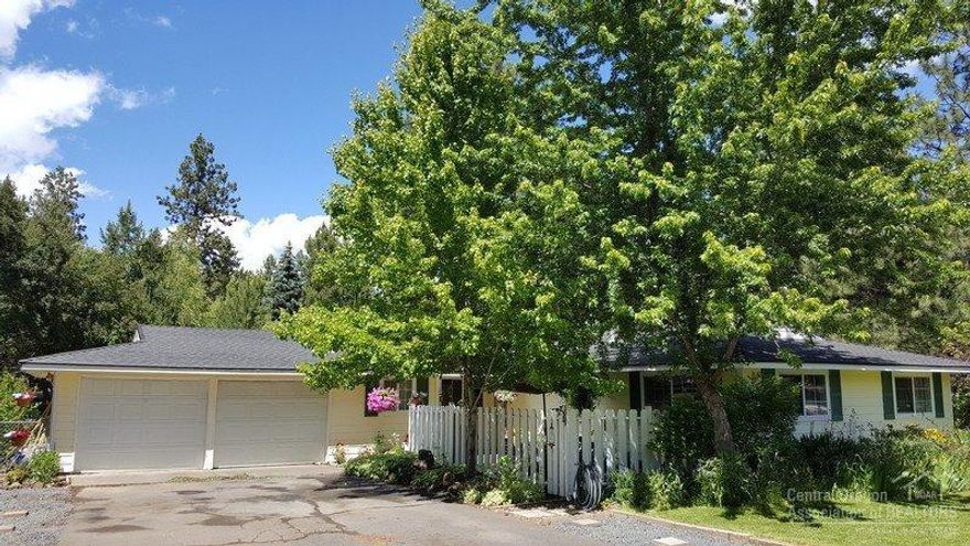 Charming single level home in desirable Tillicum Village. Hard to find 4 bedroom 2 bath on a spacious .38 acre lot. Park like setting with beautiful landscaping and an inviting courtyard. RV parking and a fire pit for those warm summer Bend evenings. Features include a wood burning gas insert in the great room with an open and inviting floor plan. Amenities include wood flooring, granite tile countertops and tiled bathroom floors.All this amidst the lush trees of Tillicum Village backing a large common area