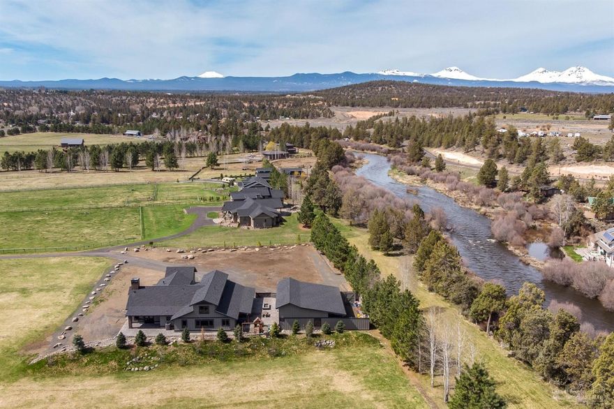 Rare, newly completed Tumalo custom home w/acreage along 100's of feet of river frontage, offering elbow room yet a 5 min. drive to town. With fruit orchard, 4 irrigated Ac & graded land, you're ready for anything from soccer to hobby farm living on nearly 6 Acres. Fish from backyard, float home from Tumalo Park, entertain, work the land, or simply relax. Built by a top local builder, the 4360 SF main home perfectly captures what is the modern farmhouse w/crisp white & dark tones & natural wood accents. 2 suites, Lg study, Grt Rm w/2 story brick FP & access to both side & back yards on main level. Kitchen w/space for banquet dining & a huge island. FP & KitchenAid appliance pkg beautifully continues the look of black brass, white & stainless we see throughout. 2 more bedrooms & a full bath up. 2nd structure w/another 3 car garage in addition to the one attached to the main home outfitted w/projection TV, FP, pool table, bar, bath & heated upstairs storage & covered RV parking outside.