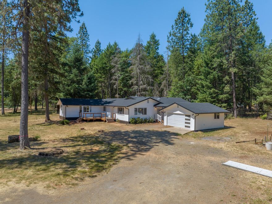 Welcome to 1442 Pickett Creek Rd! Wonderfully renovated 2616 sqft, 4 bedroom, 2 bathroom home sitting on 4.81 useable acres with a barn/shop, large covered arena with stalls & RV parking. Some interior features include vaulted ceilings, double island in kitchen, & a walk-in tile shower. Upgrades include, new heat pump, new roof, new water heater, flooring, paint, tile shower, windows, deck, & more! This is the perfect property to have animals or a large garden, with lots of privacy. Close to the Rogue River, 15-20 minutes to Grants Pass. Come see this one today!