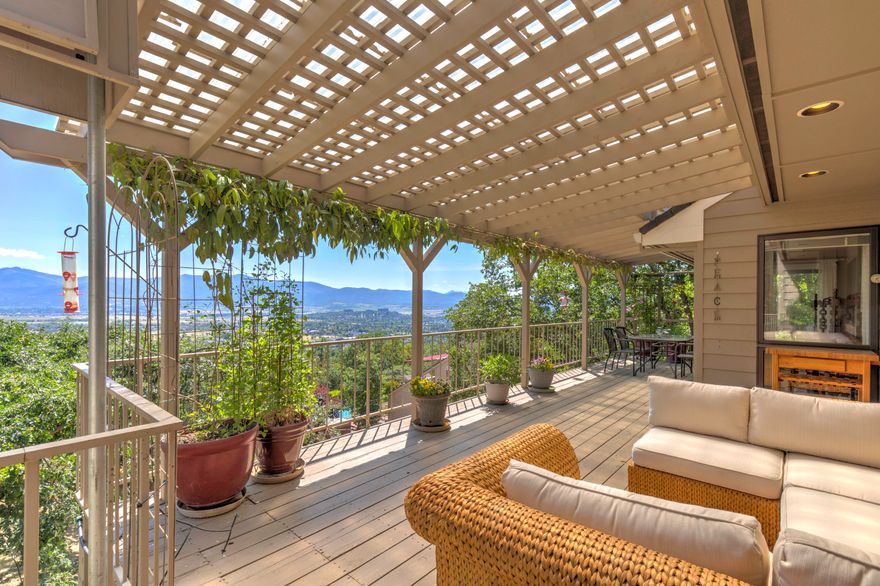 Views!!!  Custom-built, quality constructed home offers panoramic views of the majestic mountain range & the Rogue Valley.  W/multiple decks perfect for entertaining one can host unforgettable gatherings while soaking in the breathtaking scenery.  This spacious layout includes a primary suite on the main level for ease of living.  A gas fireplace creates a warm & inviting ambiance.  With an oversized .63 ac lot, this prop. provides peace & tranquility. Located on the desirable Mariposa Terrace, this property offers million-dollar views and features an abundance of natural light flowing through the large windows. Private suite downstairs, perfect for guests. Tandem parking in the garage/workshop/extra storage. Exterior power hoist.  RVCC, wineries & two regional medical centers nearby.  Extraordinary opportunity to own a slice of privacy & paradise. Hoover School dist. One year home warranty included.