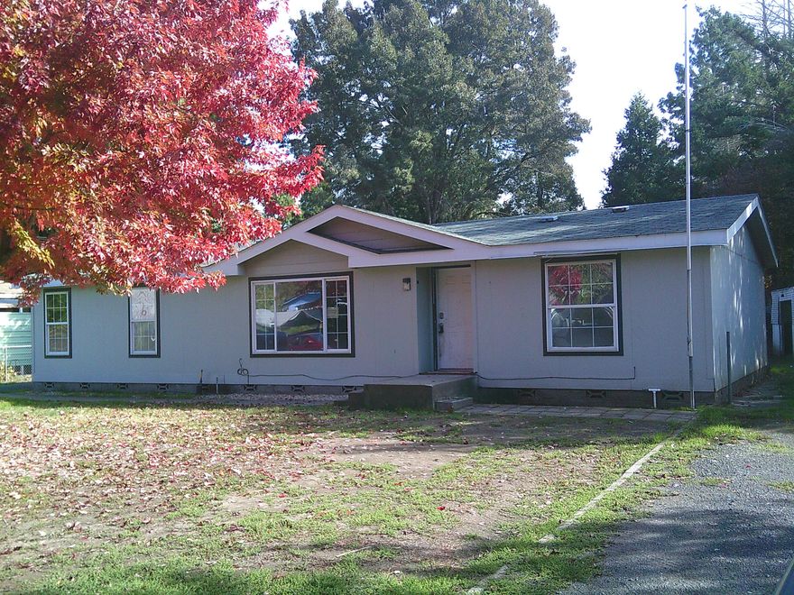 Large lot with a 3 bedroom 2 bath 1456 sq ft manufactured home and a 988 sq ft detached garage with shop and storage. Property has irrigation, sewer, water and natural gas available.